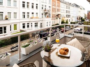 a table with a plate of food on a balcony at Altstadt Geverdes 2 in Lübeck