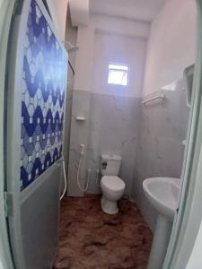 a bathroom with a toilet and a sink at AMM Rooms in Nikawatawana +3 photos