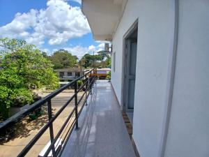 a balcony with a view of a building at AMM Rooms in Nikawatawana