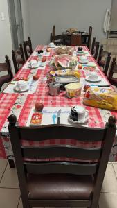 a table with a table cloth with food on it at Hotel Karisma II in São Bernardo do Campo