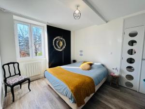 a bedroom with a bed and a chair and a window at Le Cosy, Rives Entre Lyon et Grenoble, lit Queen 160, 4 pers, Calme côté jardin in Rives