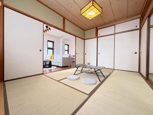 ein Wohnzimmer mit einem Tisch und einem Sofa in der Unterkunft ura tsumo in Kasaoka