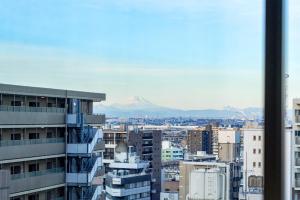a view of a city with a mountain in the background at Hotel Global View Urawa in Saitama