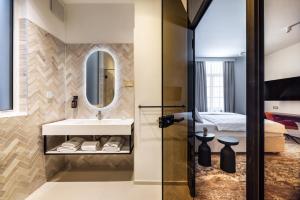 a bathroom with a sink and a mirror at Hiša F5 in Ljubljana +51 photos