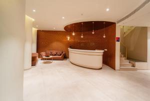 a large bathroom with a tub and a couch at Hotel Benchmark Premier in Indore +33 photos