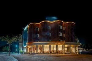 a large building with lights on it at night at Hotel Benchmark Premier in Indore