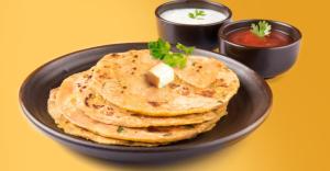 a plate of tortillas with a pat of cheese and salsa at Tivoli Bijwasan in Jāmb