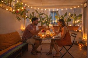 a man and a woman sitting at a table with food at Lydian Suite in Bari +11 photos