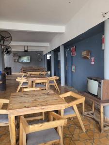 a group of wooden tables in a room at KimyaKimya Pub & Lodge in Dar es Salaam +18 photos