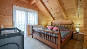 a bedroom with a bed in a log cabin at Villa Nina by Villas Guide in Ludbreg +29 photos