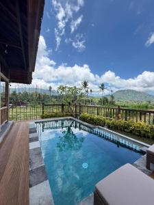 a swimming pool in the middle of a house at Kubu Sakian Villa and Restaurant Sidemen in Sidemen