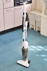 a robot is sitting on a kitchen floor at はなハウス 401 in Ginowan