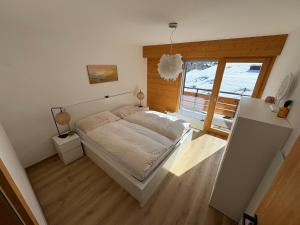 a bedroom with a bed and a large window at Appartement Nendaz, bâtiment Diana in Nendaz