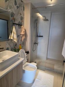 a bathroom with a sink and a toilet and a shower at Ideal homes in Gatunga