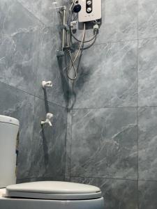 a bathroom with a toilet and a shower at Surf Front in Ahangama