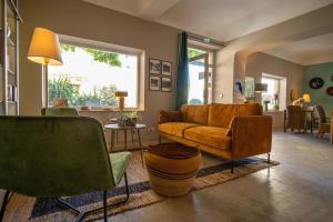 a living room with a couch and chairs at Hôtel de Mirmande in Mirmande
