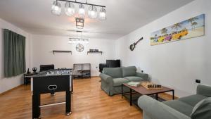 a living room with a couch and a table at Dvori Perdedaj by Villas Guide in Beretinec