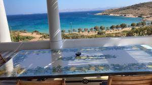 a table on a balcony with a view of the ocean at casa koklakura in Leipsoi +3 photos