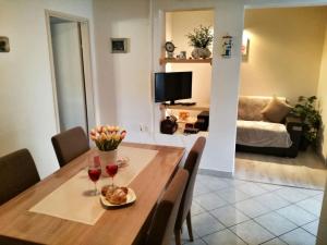 a dining room with a table with two glasses of wine at Apartments Pecotić in Brna +15 photos