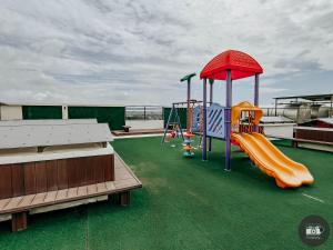 a playground on a cruise ship with a slide at Modern Studion with 2 Queen Bed in Sampong