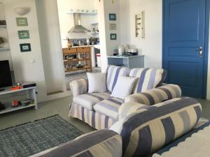 a living room with two couches and a tv at casa koklakura in Leipsoi