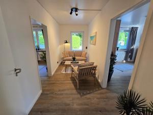 a living room with a couch and a chair at Wohnen auf dem Lande in Wiemersdorf