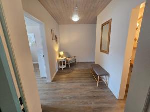 a hallway with a bench and a table in a room at Wohnen auf dem Lande in Wiemersdorf +7 photos