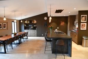 a kitchen and dining room with a long table and chairs at Chambres d'hôtes Le Pontillaou in La Garde-Freinet