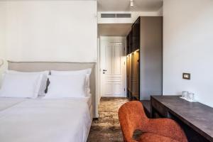 a bedroom with a bed and a desk and a chair at Hiša F5 in Ljubljana