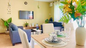 a dining room with a table with a vase of flowers at Modern House with Pool in Grand-Baie