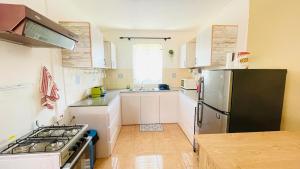 a kitchen with a stainless steel refrigerator and a stove at Modern House with Pool in Grand-Baie