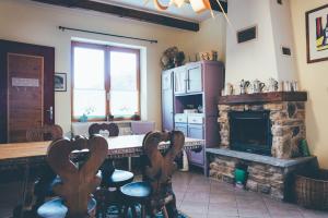 a kitchen with a fireplace and a table and chairs at B&B del Villaggio in Argentera +17 photos