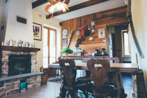 a kitchen with a fireplace and a table and chairs at B&B del Villaggio in Argentera