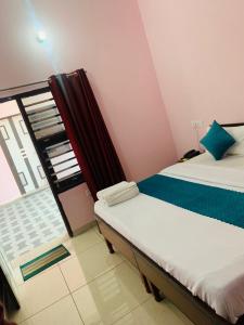 a small room with two beds and a balcony at Hotel Mahadev Home-Stay !! Near Chandigarh It'l Airport in Chandigarh Airport