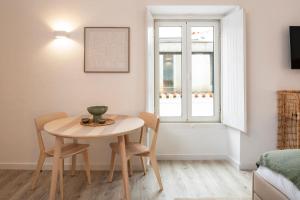 a small table and chairs in a room with a window at Alma da Vida Ferragudo in Ferragudo +35 photos