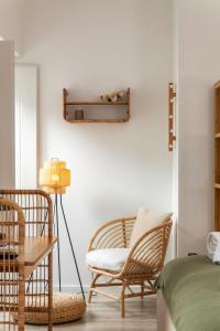 a bedroom with a chair and a table and a bed at Alma da Vida Ferragudo in Ferragudo