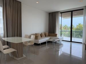 a living room with a couch and a table and chairs at The 211 Rayong in Ban Phlong Sawai