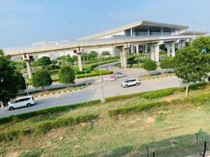 a parking lot with cars parked in front of a building at Hotel Mahadev Home-Stay !! Near Chandigarh It'l Airport in Chandigarh Airport