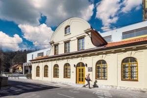 a person walking down a street in front of a building at Hiša F5 in Ljubljana