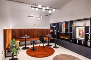 a restaurant with tables and chairs in a room at Hiša F5 in Ljubljana