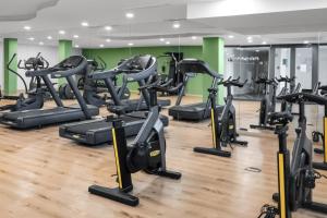 a gym with many tread machines in a room at Oasys de Ipanema in La Cala de Mijas