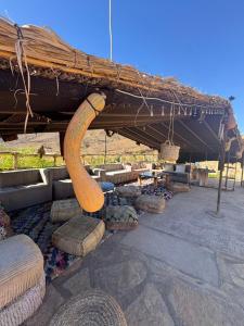a large wooden object sitting under a roof at Lodge bio berber nomad in Nkob