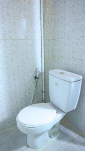 a bathroom with a white toilet in a room at Artemis Hotel Bekasi in Cikunir Satu