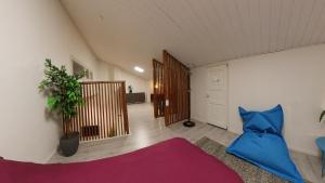 a living room with a bed and a hallway at Keskuskarintie 9 A3 in Kalajoki +8 photos