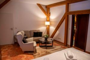a living room with a couch and a table at Sophienhof in Bad Berka