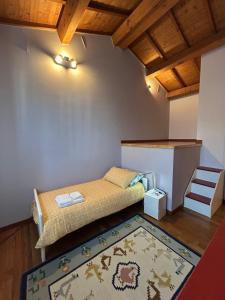 a small room with a bed and a rug at CasaVolta in Padova