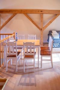 a dining room with a table and chairs and a bed at Sophienhof in Bad Berka