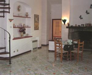 a dining room with a table and a fireplace at Villa Brigio in Forio d'Ischia