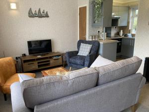 a living room with a couch and a kitchen at 35 Siesta Mar in Mundesley