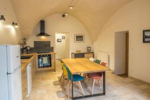 a kitchen with a wooden table and chairs at le clos de la monne in Saint-Amant-Tallende +9 photos